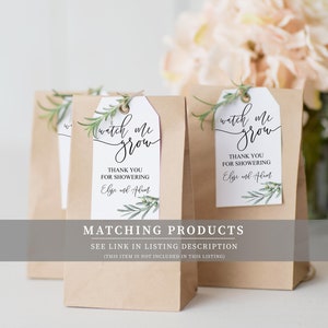 May include: Brown paper bags with white tags that say "watch me grow" and "Thank you for showering [name] and [name]" with a green leafy design. The text "Matching Products" is below the bags with the text "See link in listing description (This item is not included in this listing)".