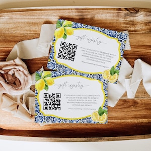 May include: Two blue and white patterned cards with lemons and a QR code. The text on the cards reads "gift registry" and includes a website address.