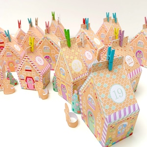 May include: An assortment of gingerbread house-shaped advent calendar boxes. Each box is decorated with colorful details and a number from 1 to 24. Small gingerbread man and Christmas tree cutouts are also present.