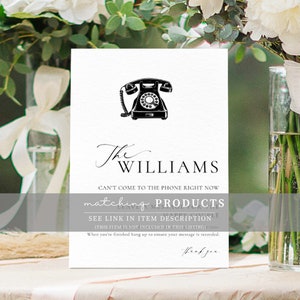 May include: A white card with a black vintage rotary phone illustration. The text "The WILLIAMS" is written in cursive script. The text "Can't come to the phone right now" is written in black. The text "matching PRODUCTS" is written in gray. The text "LEAVE A MESSAGE FOR THE HAPPY COUPLE" is written in gray. The text "SEE LINK IN ITEM DESCRIPTION" is written in gray. The text "(THIS ITEM IS NOT INCLUDED IN THIS LISTING)" is written in gray. The text "When you're finished hang up to ensure your message is recorded." is written in gray. The text "Thank you" is written in gray.
