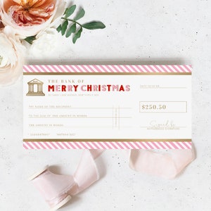 May include: A festive check design with pink and gold accents. The text reads "The Bank of Merry Christmas" in red and pink. The check includes fields for recipient, amount, and signature, with a value of $250.50.