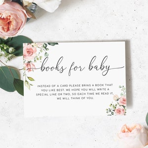 以下が含まれることがあります： ピンクの花柄のイラストが描かれた白いカードに「books for baby」の文字が書かれています。カードには、カードの代わりに本を持参し、本に特別な行を1行か2行書いてくださいと書いてあります。