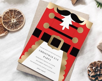 May include: A Christmas Eve party invitation featuring a red nutcracker design with gold accents and black details. The invitation includes the text "CHRISTMAS EVE PARTY" and event details. The invitation is on a kraft paper envelope.