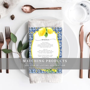 May include: A blue and white tiled menu card with a watercolor illustration of lemons. The menu text reads "menu", "Entree: Antipasto Platters", "Main: Twice cooked shoulder of lamb, fresh mint salsa, roasted Lockyer Valley vegetables", "Honey brined chicken, crispy speck, ancient grain salad, smoked cure".