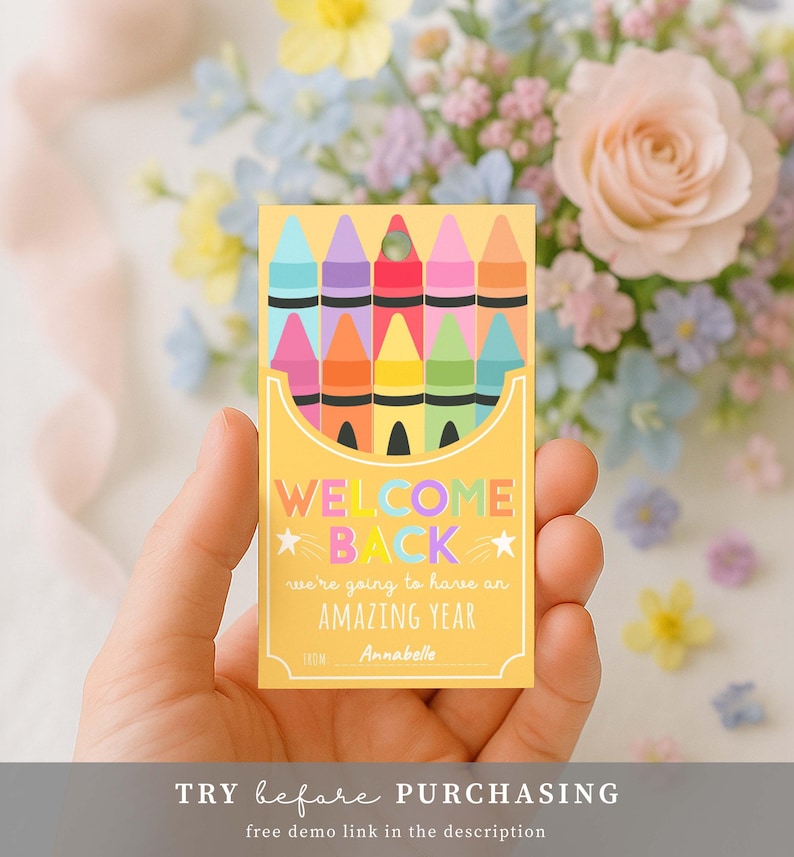 May include: A yellow card with a crayon box design, featuring the text "WELCOME BACK" and "we're going to have an AMAZING YEAR". The card is held in a hand, with a floral background.