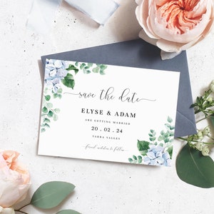 May include: Save the date card with a watercolor design of blue hydrangeas and green leaves. The text reads "Save the date", "Elyse & Adam", "Are getting married", "20.02.24", "Yarra Valley", and "Formal invitations to follow".