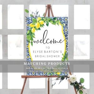 May include: Welcome sign for a bridal shower with a blue and white tiled background and a wreath of lemons and green leaves. The text reads "Welcome to Elyse Barton's Bridal Shower".