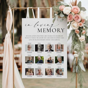 May include: A white sign with the words "in loving memory" in elegant script. Below, a message is printed, and photos of loved ones are arranged in a grid. The sign is decorated with a floral arrangement of pink and white roses.
