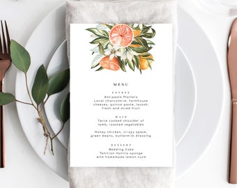 May include: A wedding menu with a floral illustration of citrus fruits, leaves, and blossoms. The menu lists the entree, main course, and dessert options. The entree is Antipasto Platters, the main course is Twice cooked shoulder of lamb, roasted vegetables or Honey chicken, crispy speck, green beans, buttermilk dressing, and the dessert is Wedding Cake, Tahitian Vanilla sponge with homemade lemon curd.