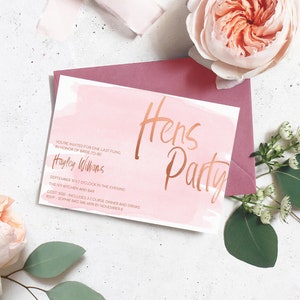 May include: A pink and white watercolor invitation with rose gold lettering for a Hens Party. The invitation includes the bride-to-be's name, Hayley Williams, the date and time of the event, the location, The Ivy Kitchen and Bar, the cost, $120, and the RSVP information.
