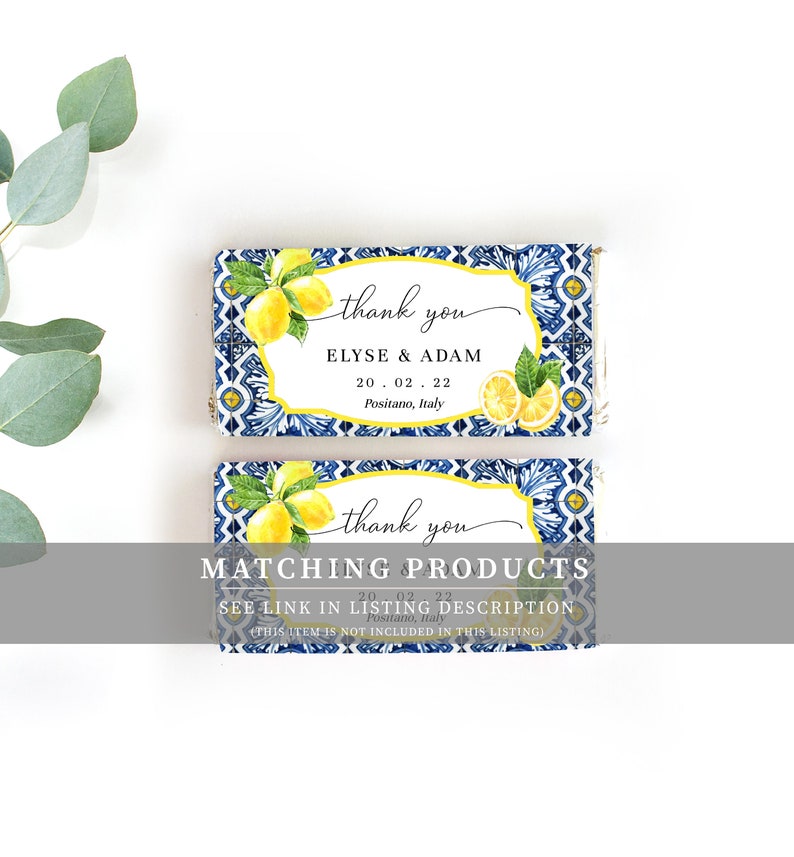 May include: Two blue and white tiled favor boxes with a lemon design. The top box says "thank you" and "Elyse & Adam" with the date "20.02.22" and "Positano, Italy". The bottom box says "thank you" and "MATCHING PRODUCTS" with the date "20.02.22" and "Positano, Italy". The text "SEE LINK IN LISTING DESCRIPTION (THIS ITEM IS NOT INCLUDED IN THIS LISTING)" is also on the bottom box.