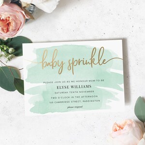 May include: A baby sprinkle invitation with a watercolour background in shades of green and gold lettering. The invitation reads "baby sprinkle" and includes the name "Elyse Williams", the date "Saturday Tenth November", the time "Two O'Clock in the Afternoon", the address "160 Cambridge Street, Paddington", and the phrase "please respond".