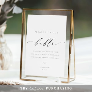 May include: A white sign with gold trim in a gold frame, with the text "PLEASE SIGN OUR bible" in black cursive font. The sign also includes the text "HIGHLIGHT YOUR FAVORITE VERSE AND WRITE US A NOTE IN THE MARGIN. THIS WILL BECOME OUR FAMILY BIBLE." and "ELYSE ADAM 06.06.VY".