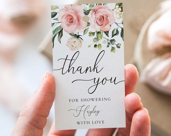 May include: A white thank you tag with a floral design featuring pink and white roses and green leaves. The tag says "thank you" in cursive script and "for showering Hayley with love".