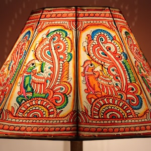 May include: A colorful lampshade with a hand-painted design featuring peacocks and floral patterns in shades of red, orange, green, blue, and yellow.