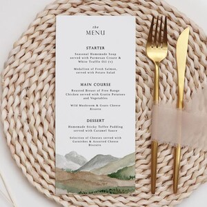 May include: A menu card with a watercolor illustration of a mountain landscape. The menu features a starter, main course, and dessert. The text on the menu card reads: "the MENU, STARTER, Seasonal Homemade Soup served with Parmesan Croute & White Truffle Oil (v), Medallion of Fresh Salmon, served with Potato Salad, MAIN COURSE, Roasted Breast of Free Range Chicken served with Gratin Potatoes and Vegetables, Wild Mushroom & Goats Cheese Risotto, DESSERT, Homemade Sticky Toffee Pudding served with Caramel Sauce, Selection of Cheeses served with Garnishes & Assorted Cheese Biscuits."