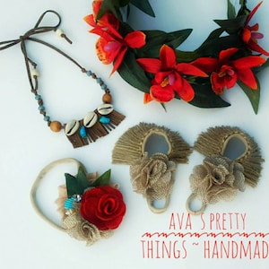 May include: A collection of handmade accessories, including a necklace with shells and turquoise beads, a floral headband, and two burlap-style hair accessories. A wreath of red orchids and green leaves is also present. The text "AVA'S PRETTY THINGS ~ HANDMADE" is visible.