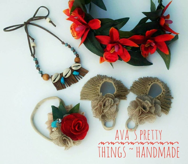 May include: A collection of handmade accessories, including a necklace with shells and turquoise beads, a floral headband, and two burlap-style hair accessories. A wreath of red orchids and green leaves is also present. The text "AVA'S PRETTY THINGS ~ HANDMADE" is visible.