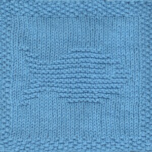May include: A blue knitted dishcloth with a woven pattern. The dishcloth is made of cotton and is designed to be absorbent and durable.