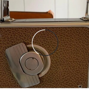 May include: A vintage silver and brown camera with a leather covering and a silver winding knob.