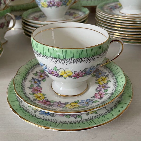 EB Foley Vintage Bone China Trio, Cup, Saucer and Plate.  Partially Hand-Painted Floral Pattern, Pale Green Border on White Background.