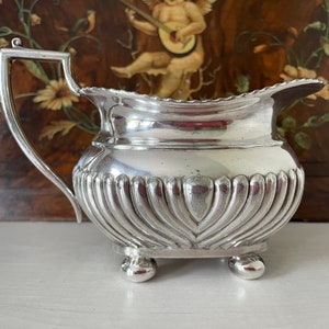 Martinoid Milk Jug/Creamer Made by Martin Hall and Co, English Silversmiths.  Footed with Half Rib Design.