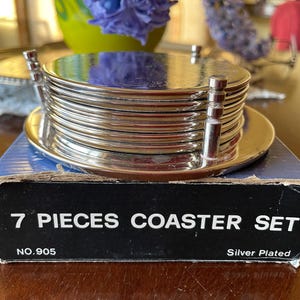 Ornate, Silver Plated 7 Piece Coaster Set, Six Coasters and Stand/Wine Coaster. Silver Plated Vintage Bar Ware.  Still in Original Box.