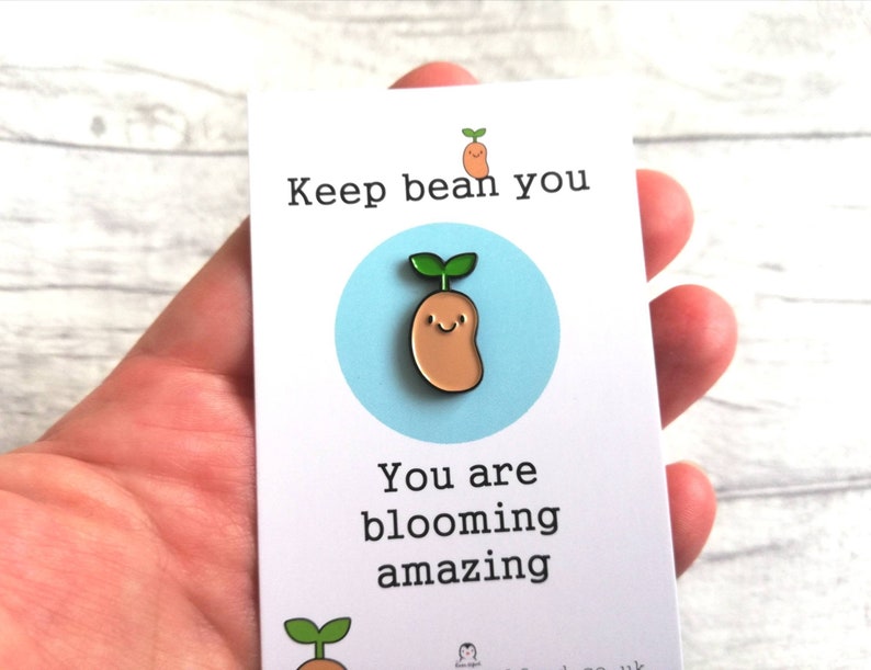 May include: A white card with the text "Keep bean you" and "You are blooming amazing". A cartoon bean sprout with a smiling face is in the center of the card.