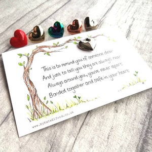 May include: A white rectangular card featuring a hand-drawn tree illustration and the text: This is to remind you of someone dear, And just to tell you they are always near, Always around you, you're never apart, Bonded together and safe in your heart.