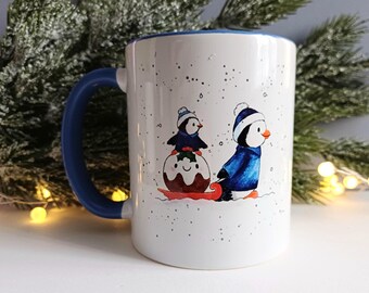 Taza de cerámica con pingüinos navideños, trineo y pudín