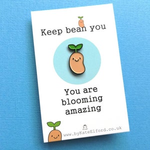 May include: A white card with a green and brown bean sprout illustration and the text "Keep bean you, you are blooming amazing" and a website address at the bottom.