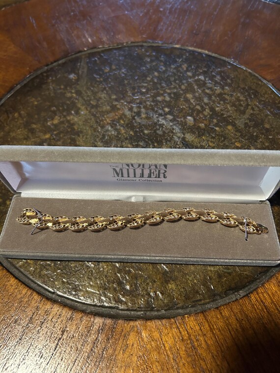 Nolan Miller brushed gold intertwined faux diamonds in box