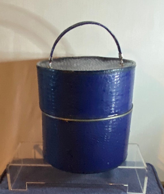 Vintage faux reptilian embossed blue vinyl round suitcase.