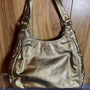 sac à main Coach vintage métallisé doré porté épaule ou main