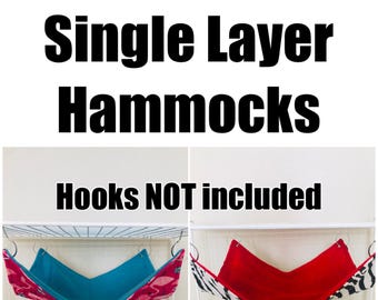 May include: Image shows two single-layer hammocks. One hammock has a pink flamingo pattern with a teal interior. The other has a zebra print exterior with a red interior. Text reads "Single Layer Hammocks" and "Hooks NOT included."