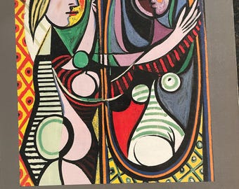 May include: A colorful Picasso art print featuring a woman's portrait with geometric shapes and bold lines. The artwork includes a figure in a mirror, with a red, yellow, and green patterned background. The word "PICASSO" is in red at the bottom.