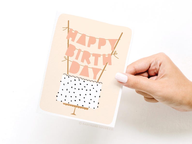 A hand holding a birthday card with the text "Happy Birthday Day" written on it.