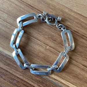 May include: A rustic wooden sign with the text "Welcome to our home" in white lettering. The sign features a distressed finish and a simple, inviting design, perfect for a front porch or entryway.