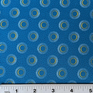 May include: A blue fabric with a repeating pattern of white and gold circles. The circles have a dotted border and a solid gold center.