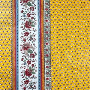 May include: Yellow fabric with a white stripe and a floral pattern. The floral pattern includes red, green, and blue flowers. The fabric has a small, repeating pattern of yellow circles with a blue center.