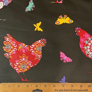 May include: Black fabric with a repeating pattern of red and pink chickens, butterflies, and flowers. The fabric is measured with a ruler that says "Do you have it all covered? 1/4".