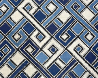May include: A geometric fabric pattern featuring a repeating design of blue, white, and black diamond shapes. The diamonds are outlined with black lines and filled with varying shades of blue and white. The fabric has a textured appearance.
