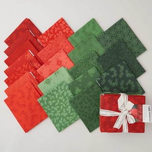 May include: A fat quarter fabric bundle featuring a collection of red and green cotton squares with various floral and botanical patterns. One stack is tied with a white ribbon, and the text on the label reads Ruby Star Society Fat Quarter Bundle.