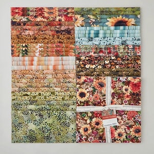 May include: A collection of fabric squares with various floral and patterned designs. The fabrics feature sunflowers, leaves, and other botanical elements in shades of orange, red, green, and blue. The bundle is tied with a white ribbon and includes a tag that reads "Sunset Garden".