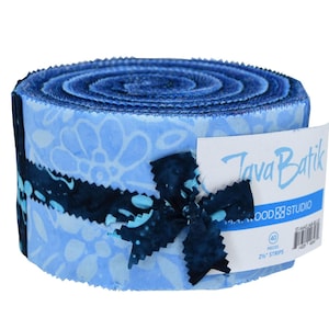 May include: A rolled bundle of blue fabric strips, featuring floral patterns and dark blue accents. The label reads "Java Batik" and indicates 40 pieces of 2.5" strips. A dark blue fabric bow secures the bundle, ideal for quilting and fabric crafts.