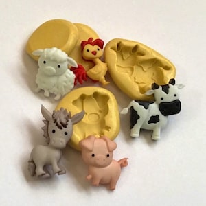 May include: A set of six silicone molds for making farm animal-shaped decorations. The molds are yellow and feature a pig, a donkey, a cow, a sheep, a rooster, and a blank mold.
