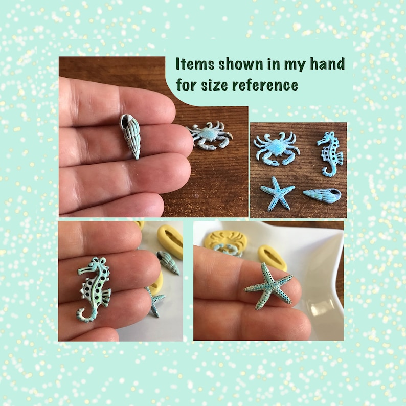 May include: A collection of small, sea-themed charms in various shapes, including a seahorse, starfish, crab, and seashells. The charms are primarily light blue and white, with a distressed finish. The text "Items shown in my hand for size reference" is visible.