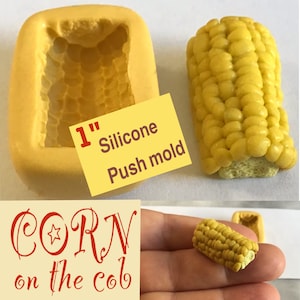 May include: A 1-inch silicone push mold for making corn on the cob. The mold is yellow and has a detailed texture. The image also shows a finished corn on the cob made with the mold.