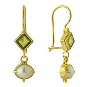 May include: Gold dangle earrings with a pearlescent white pearl and a square green gemstone.