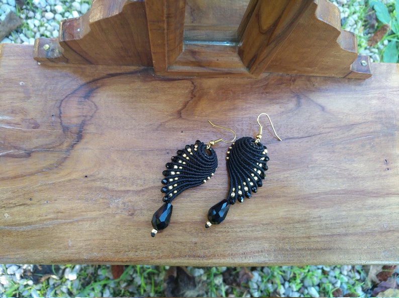 Black and golden macram\u00e8 earrings in wings shape
